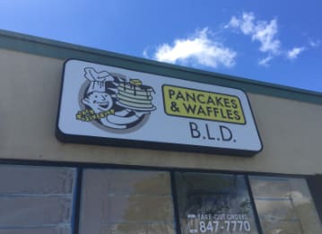 Aluminum cabinet sign for B.L.D. Pancakes & Waffles with a chef logo
