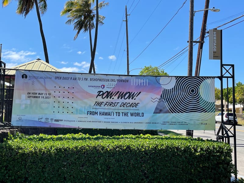 Bishop Museum entrance banner for POW! WOW! The First Decade, with exhibit dates and sponsors