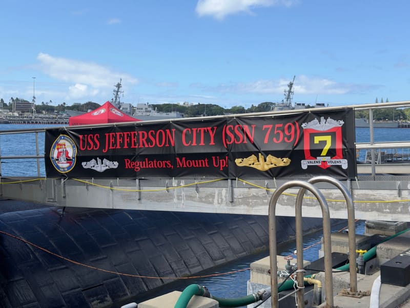 USS Jefferson City (SSN 759) welcome banner hung on the pier at Pearl Harbor