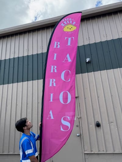 Pink feather flag printed for a birria tacos food vendor