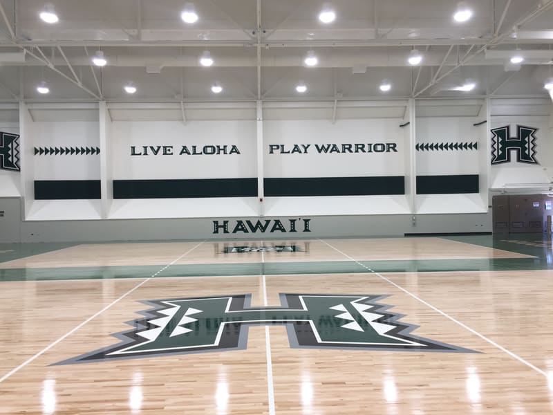 University of Hawaii court with a painted H logo and Live Aloha Play Warrior wall lettering