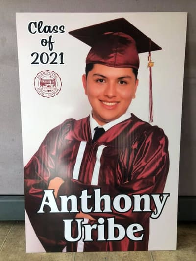 Class of 2021 graduation sign with a cap-and-gown portrait