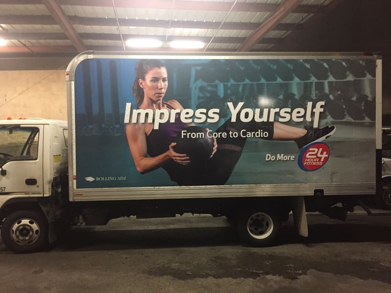 Box truck wrapped with a full-color 24-hour fitness gym advertisement