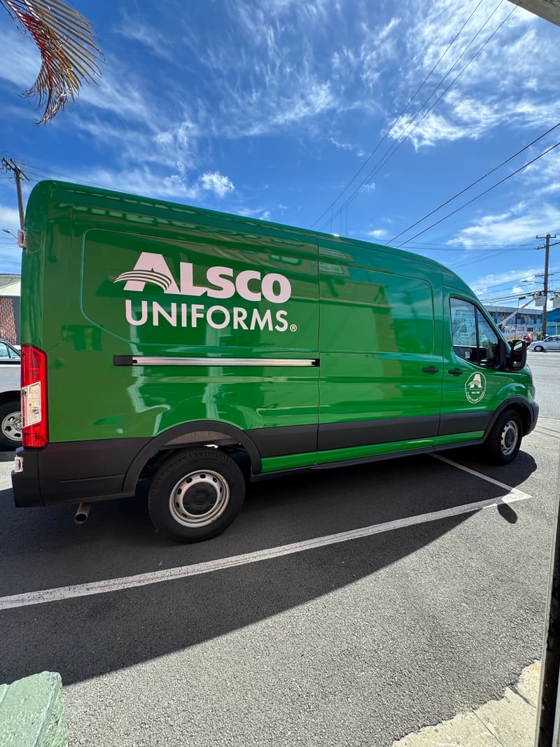 Alsco Uniforms cargo van wrapped in green with logo lettering