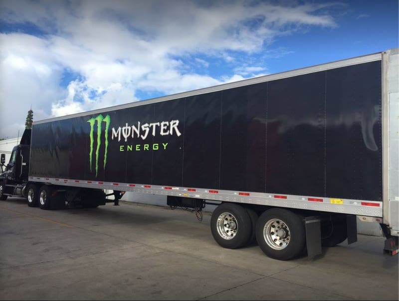 Monster Energy semi trailer with a full-length black wrap