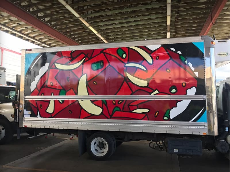 Box truck wrapped with full-color abstract red artwork